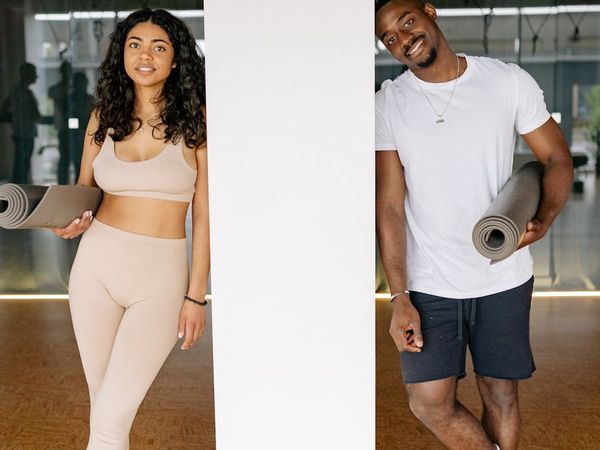 Diverse group of women smiling and holding yoga mats.